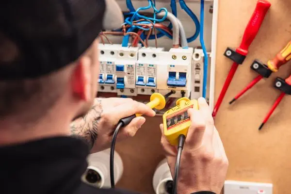 Electrician testing a circuit breaker panel